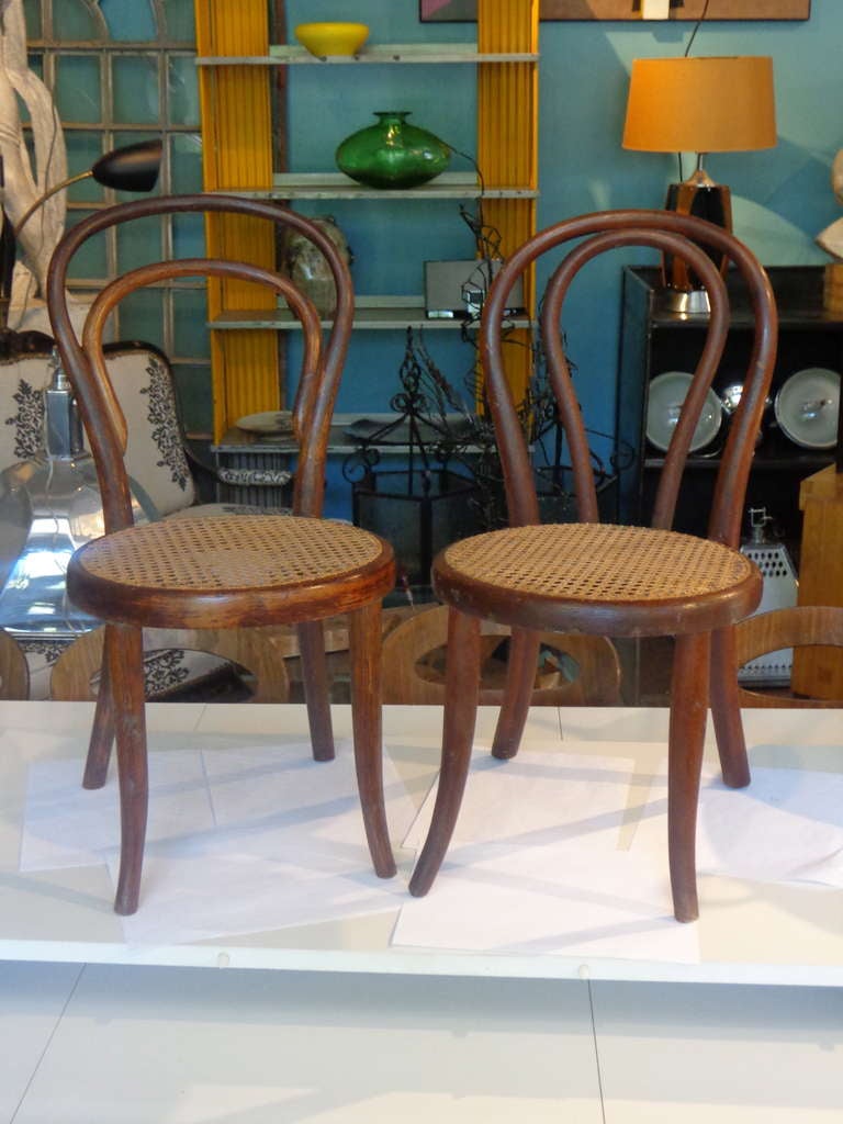 Delightful harlequin pair of early Thonet Austria bentwood child's chairs, original caning, one stamped Thonet, the other with very early paper label, Vienna Austria. one is 25