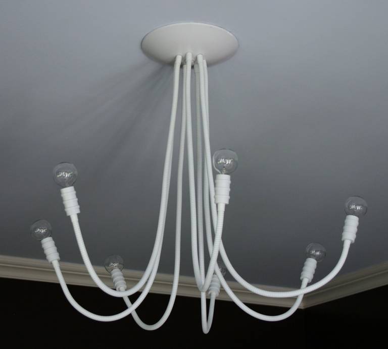 Seven-arm adjustable ceiling mounted chandelier.