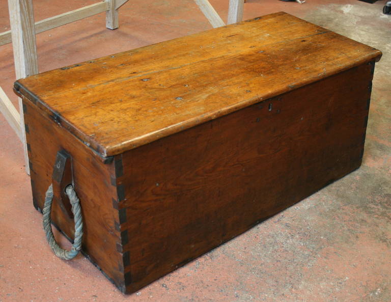 19th century pine maritime trunk with original rope handles, dovetail construction, typical angled front, remnants of original hardware, very good interior with candle box.