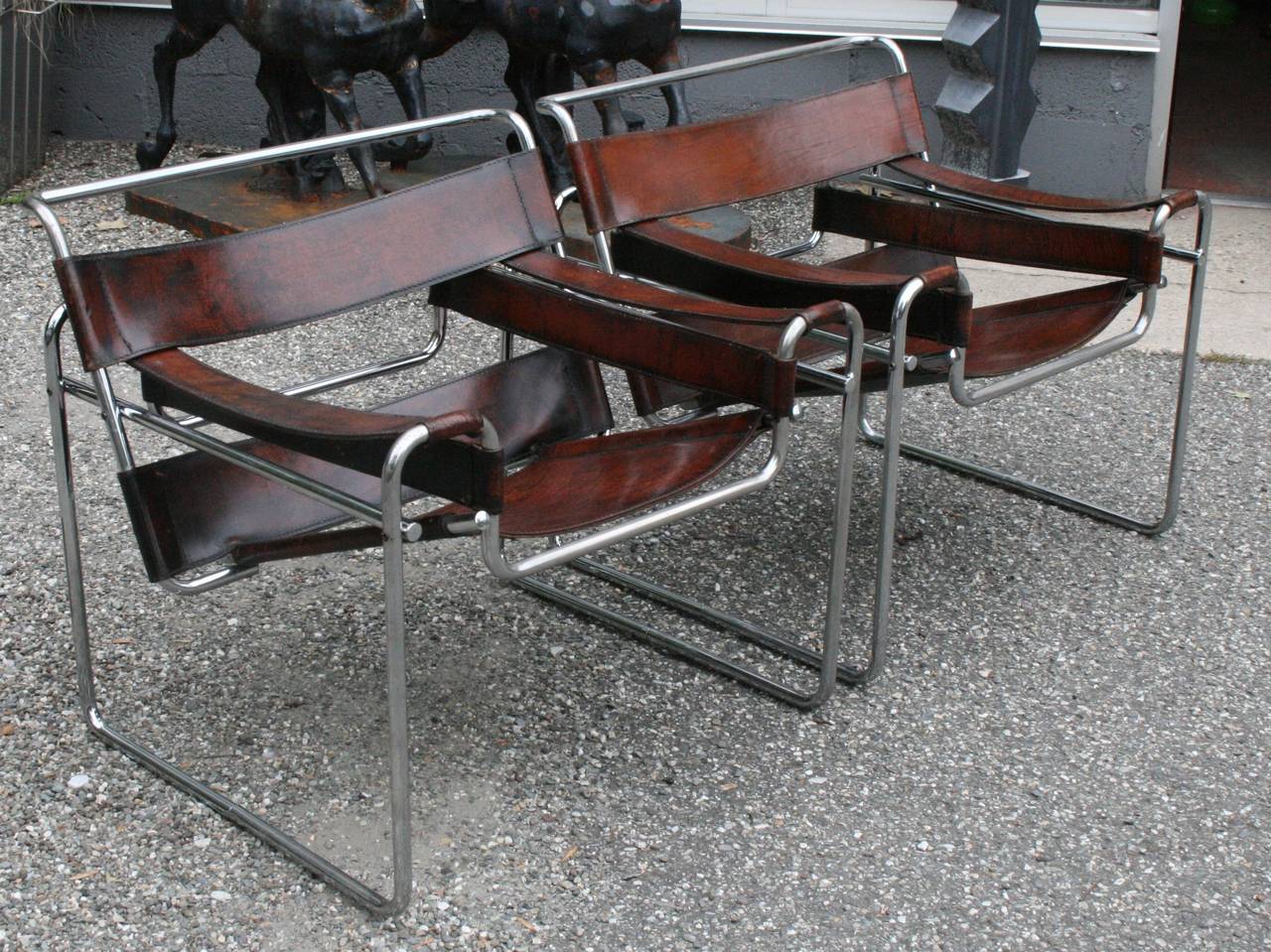 Pair of vintage Wassily chairs by Marcel Breuer with thick high quality stitched leather in a rich brown black color, chromed steel in very good condition with consistent with age.