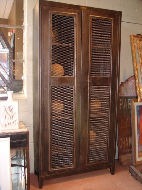 Excellent steel bookcase with interior adjustable shelving, molded mesh front double doors, original key and maker label