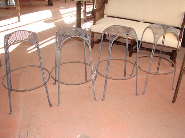 Two stools with pierced metal seats