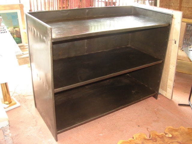 Pair of large substantial patinated steel sideboards, consoles with open shelves.