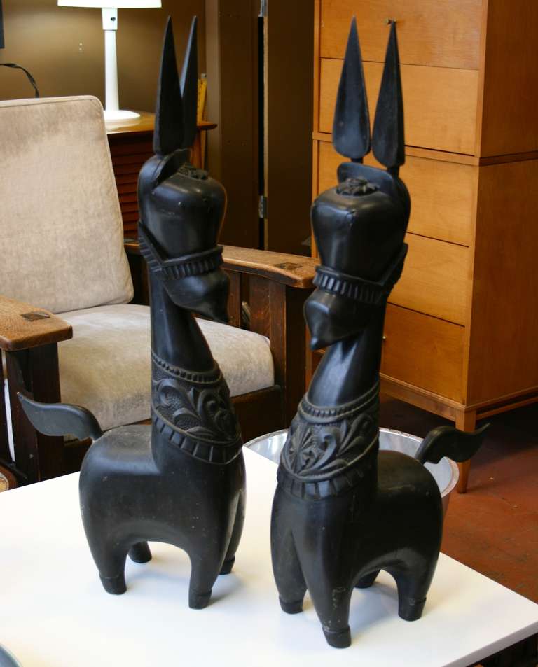Pair of unusual large scale donkey or horse figures, carved wood, original ebonized finish, good color and age. tails and ears are separate pieces.