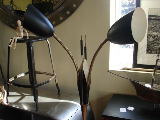 Midcentury adjustable standing lamp, brass and black enamel, with grass/cat o nine tail motif.