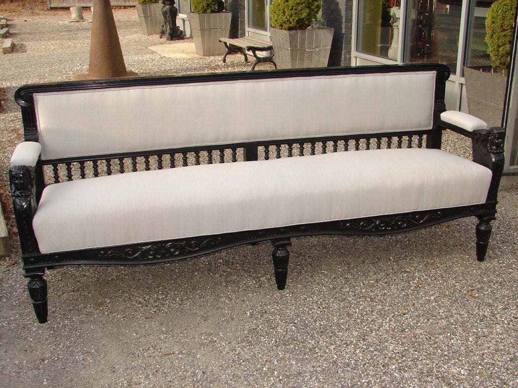 Pair of stylish substantial painted solid wood Egyptian Revival benches, with gutsy carving and Egyptian motifs, original gloss black finish, all new upholstery.