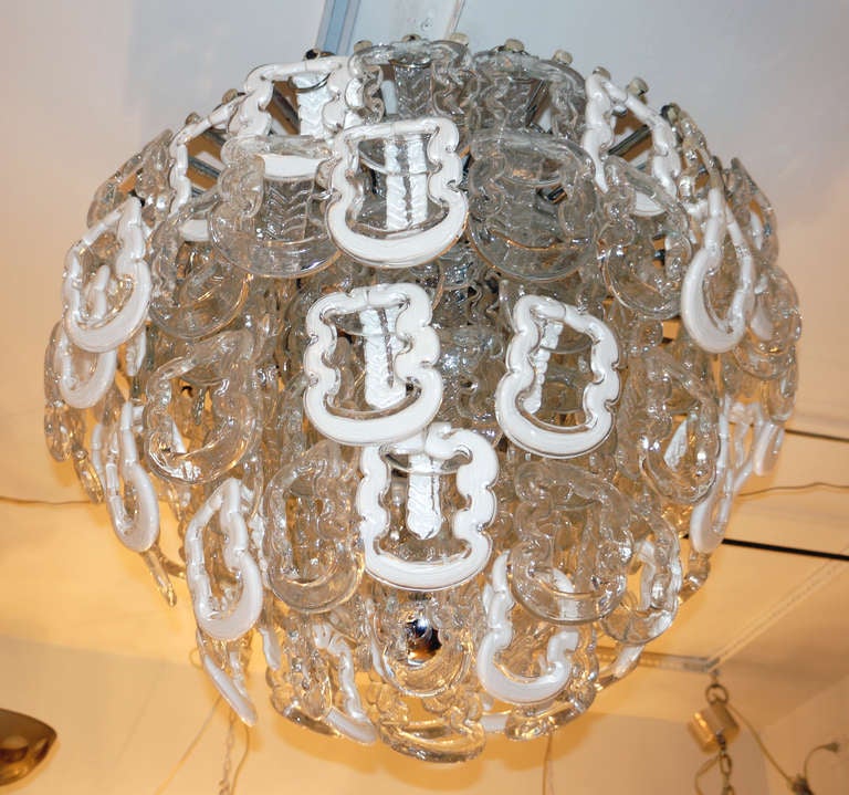 Outstanding Murano glass chandelier consisting of over 150 interlocking glasses hanging from a nickel plated metal frame. There are two types of glasses: all clear and white and clear. Glasses are distributed on four levels hiding the six-light