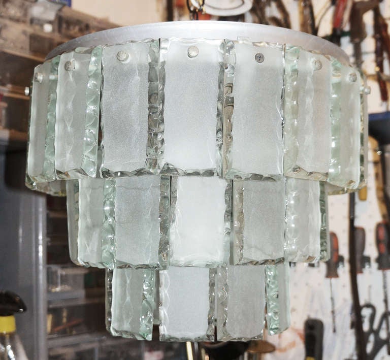 Elegant flush mount chandelier with three rows of glasses. The borders of the glasses have been hand chiseled and polished while the central sections are sanded in order to hide the three regular light sockets. The chandelier was made in the 60's or