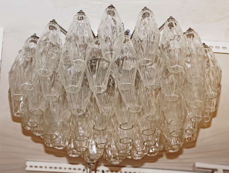 Polyhedral glasses chandeliers first designed by Carlo Scarpa for Venini became very popular in the 60's. This chandelier is shallow and medium size diameter perfect for any  low ceiling room. Glasses are all clear and do not seem to be those