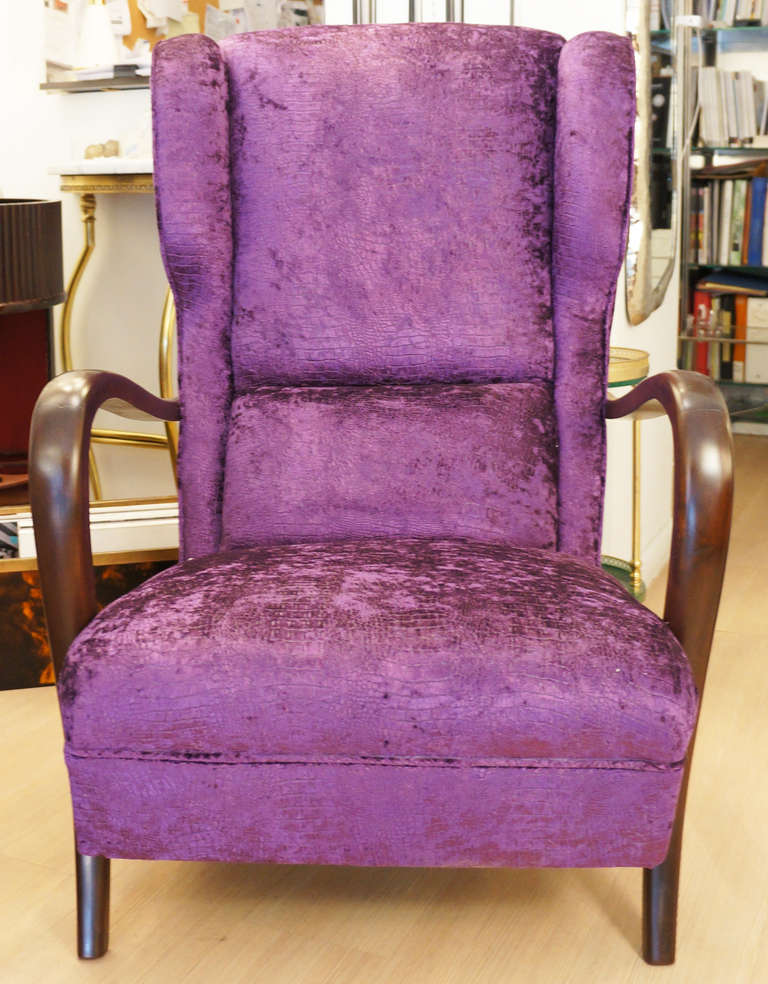 The over-sized winged top gives character to this rare pair of armchairs.
One armchair has been re-upholstered and one is in original conditions. The price listed is for both armchairs being upholstered with the fabric shown in the pictures. Both