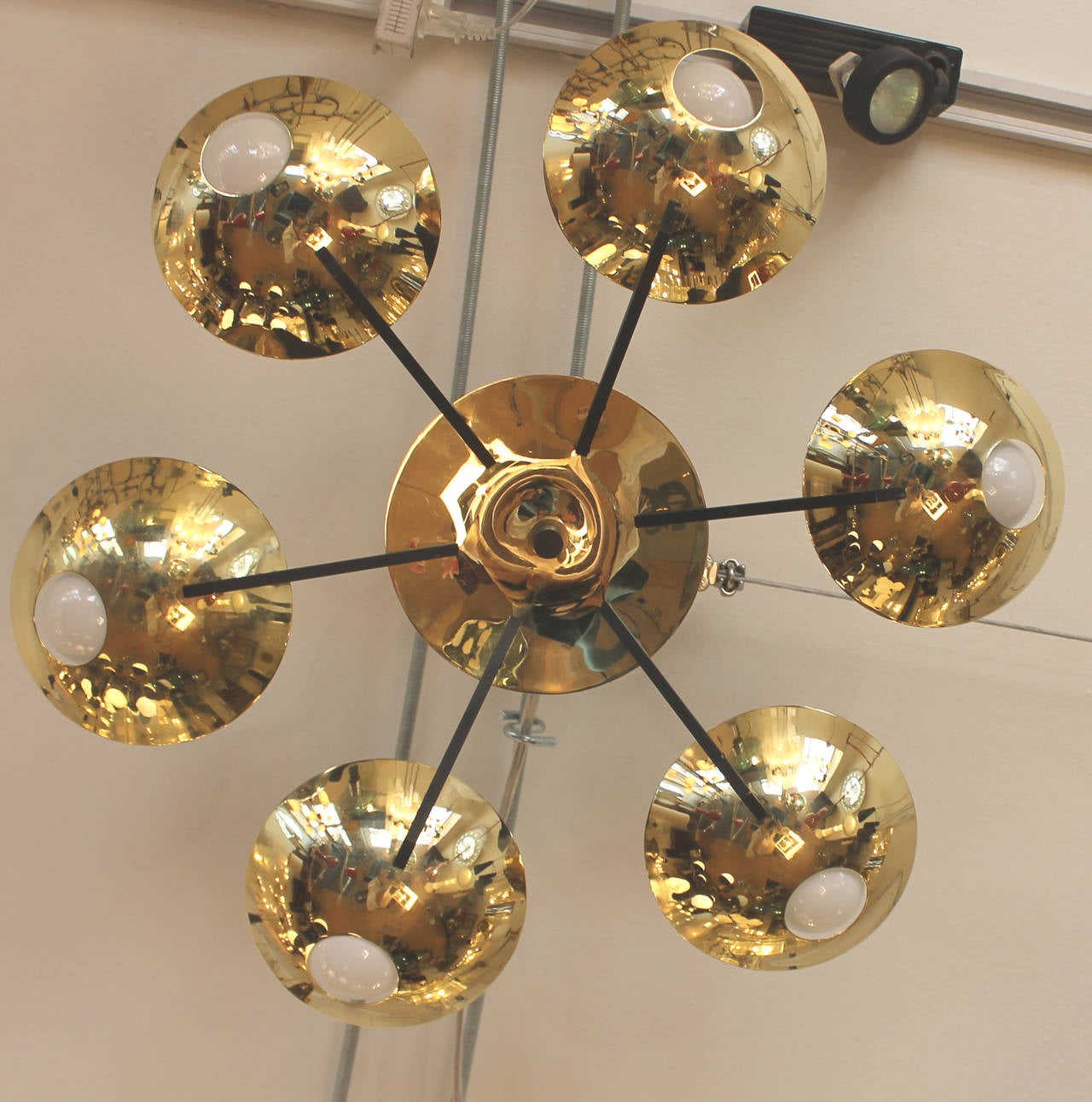 The pierced brass cups that allow the frosted light bulbs to be seen is one of the best known designs by Stilnovo. In this case, he design was applied to a flush mount lighting fixture having six brass cups connected to a central canopy by black