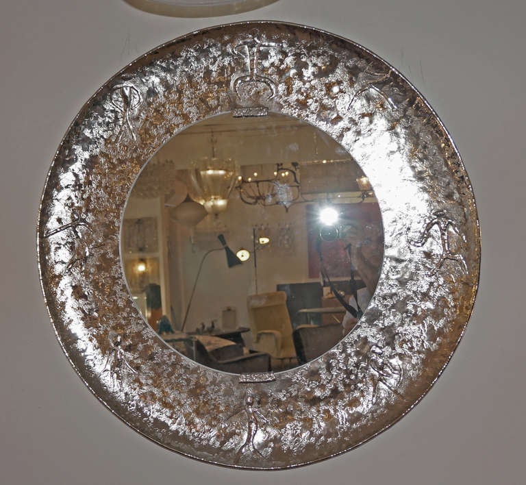 Hand hammered copper mirror with prehistoric figures. It was made in the 60's by  Bragalini a high-end artist specialized in copper artifacts and furniture. It has subsequently been nickel plated by this gallery. The nickel plating has  enhanced the