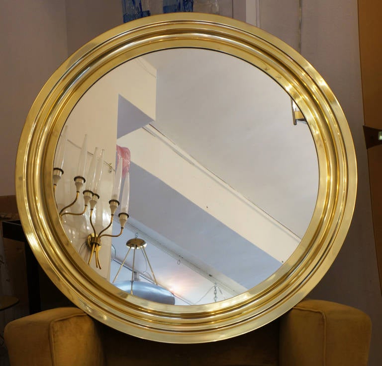 Simple and sleek round polished brass mirror. It was designed by Sergio Mazza for Artemide.