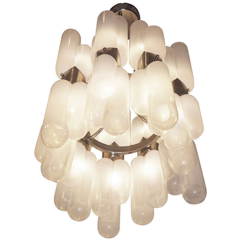 Chandelier made by Leucos in the 1960s. There are 18 three lobed glasses each one hiding a light bulb. They are attached to a round metal frame from which depart three stems ending in the canopy. Each glass is more opaque at the base and clearer at