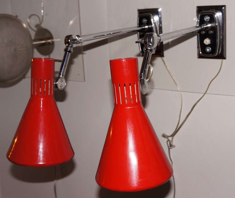 Adjustable Stilnovo sconces with three joints and switch on the back plate. The paint is in excellent condition. Marked with a label on the shade and manufacturer's name impressed on one of the joints.