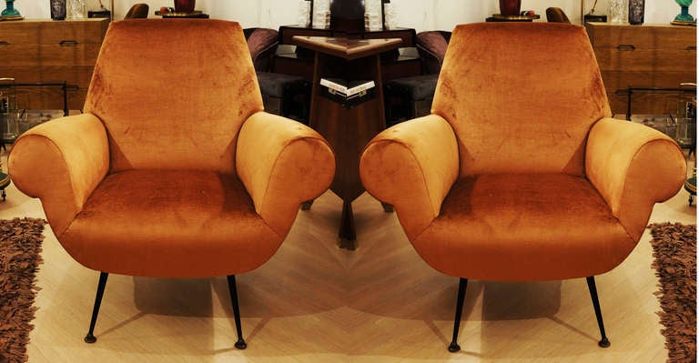 Striking and very comfortable pair of Italian armchairs with large comfortable seat and armrests. One is still in original conditions and can be re-upholstered with the same fabric for an additional cost of $700.00