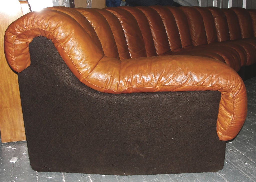 A classic of the innovative design of the 70's the sectional can curve in all directions and be adapted to the room.  This specific sofa has four sides therefore can be assembled as one sofa of 18 elements or as two sofas. Each element is 9