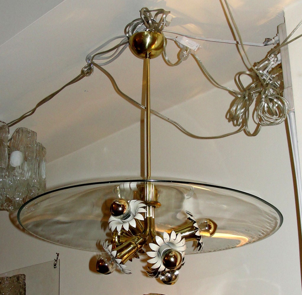 Very elegant chandelier made with six brass flowers, white lacquered inside, under a large clear glass mushroom cap. The main stem from the canopy to the glass can be replaced upon request to make the chandelier shorter or longer. Literature: Aloi,