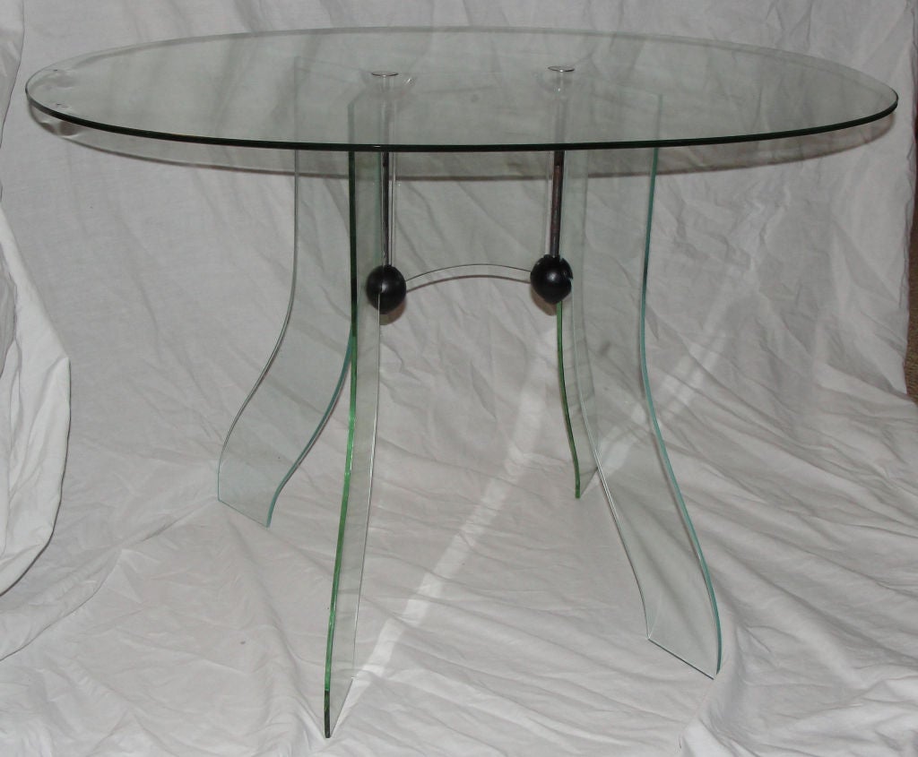 One of the first tempered glass tables made in Italy. Black wood and nickel plated brass hardware keel the pieced together and give total transparency.
