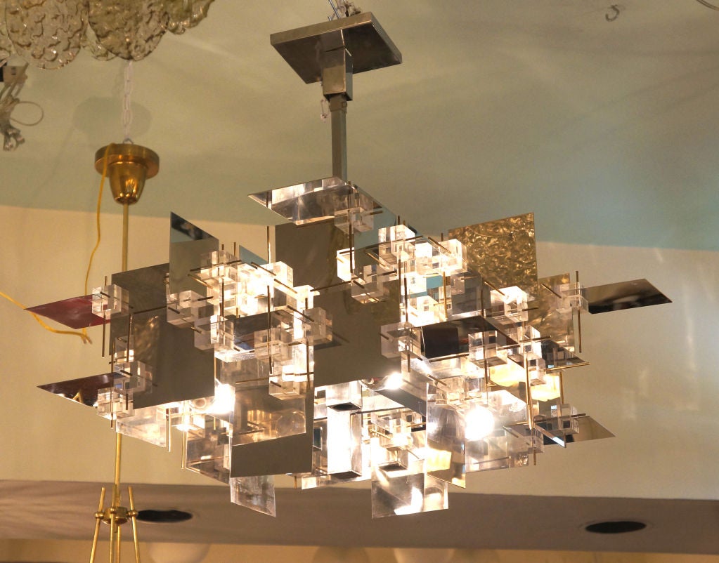 This is one of the rarest chandeliers by Sciolari a dramatic lighting designer active in Rome in the 70's. Sciolari worked on brass and nickel polished metal creating often highly irregular shapes. This particular fixture is made connecting nickel