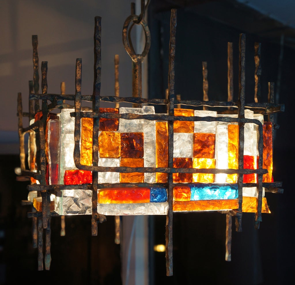 Chandelier made by Poliarte an Italian company from Verona active in the 60's and 70's that made very original glass chandeliers. Hand made, often sculpted by chisel, pieces of glass were attached together and to a metal structure. This style