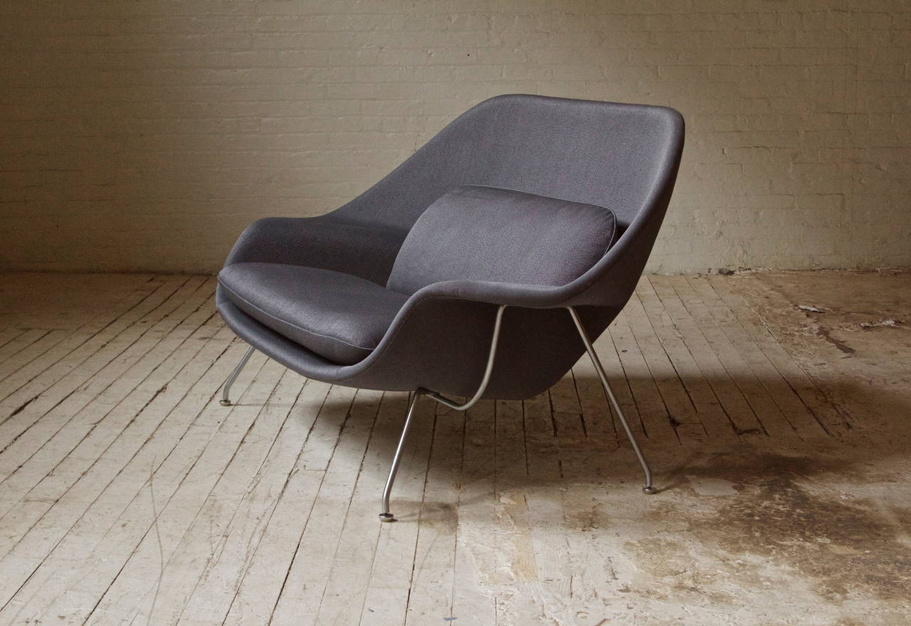 Vintage womb chair by Eero Saarinen for Knoll with original steel base, upholstered in a thick cotton-blended fabric. This piece features the trademark hand-stitched seams running along the outer contour. Very sensual design-looks good from all