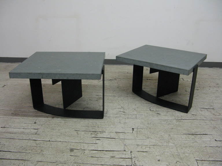 Here we have a beautiful pair of Mid-Century Modern Italian grey limestone top side tables with angular, curving black metal bases. This clean looking pair features spare, modernist design and is in good condition with minimal wear on the 2
