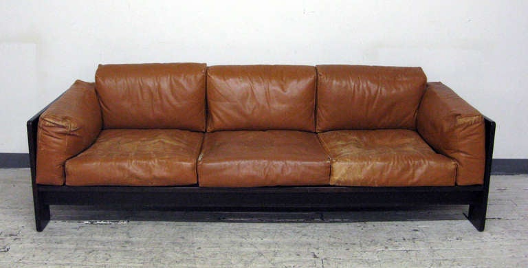Beautiful three seat Bastiano sofa in rosewood with original leather upholstered loose cushions. Designed by Tobia Scarpa in Italy in the 1960s for Gavina. Elegant line and comfortable original cushions. Gavina manufacture label attached on the