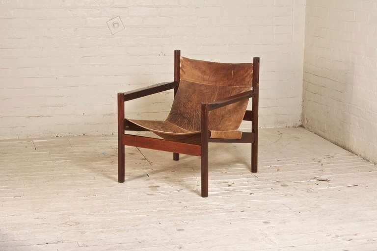 This handsome, safari-style leather sling chair, features elegant lines, and a sturdy, disassemblable construction. Demonstrating beautifully Arnoult's concept of 