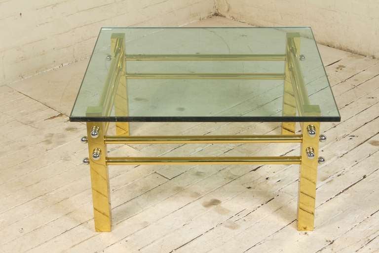 Fully-demountable, this eye-catching little table features a geometric, polished-brass frame, eight rounded stretchers with spherical chrome finials, and a beveled, smoked glass top. Made in Italy for export, this well-built little table reflects