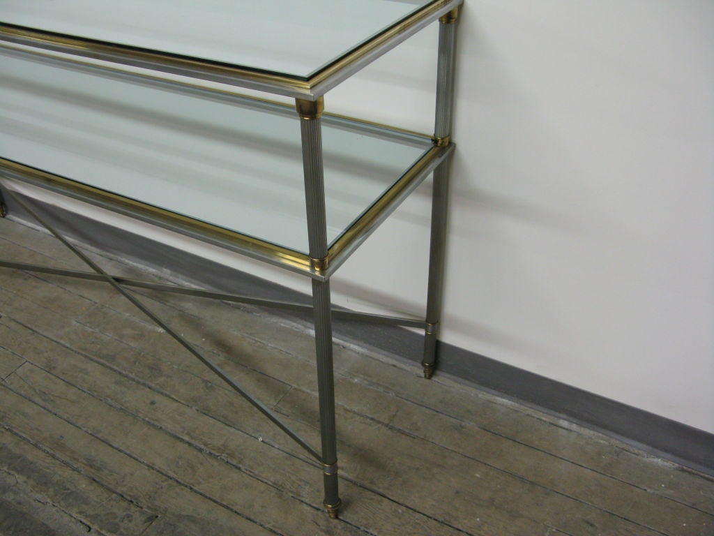 Good quality French 1950's steel and brass 2 glass top tier console table in the classical style of Luis XVI of the period.