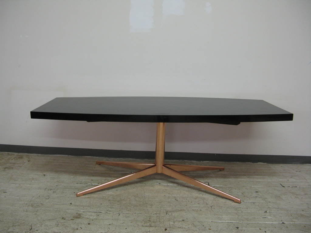 A super looking custom French black lacquer table top,with pink brass base.