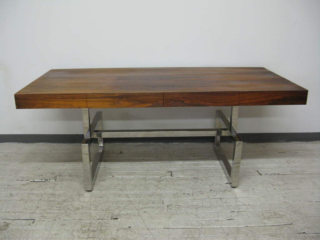 Large Midcentury desk with 2 central drawers,in exotic veneer top,supported by chrome base.