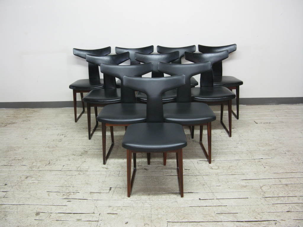 An extremely hard to find set of 10 T back rosewood dining chairs by Arne Vodder for Sibast with naugahyde upholstery.