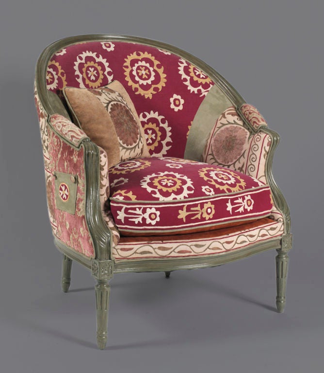 This one-of-a-kind original armchair is a vintage piece that has been hand upholstered with collected vintage fabrics that feature flavors and styles from all over the world and are hand sewn by local artisans. The charming, old-fashioned style of
