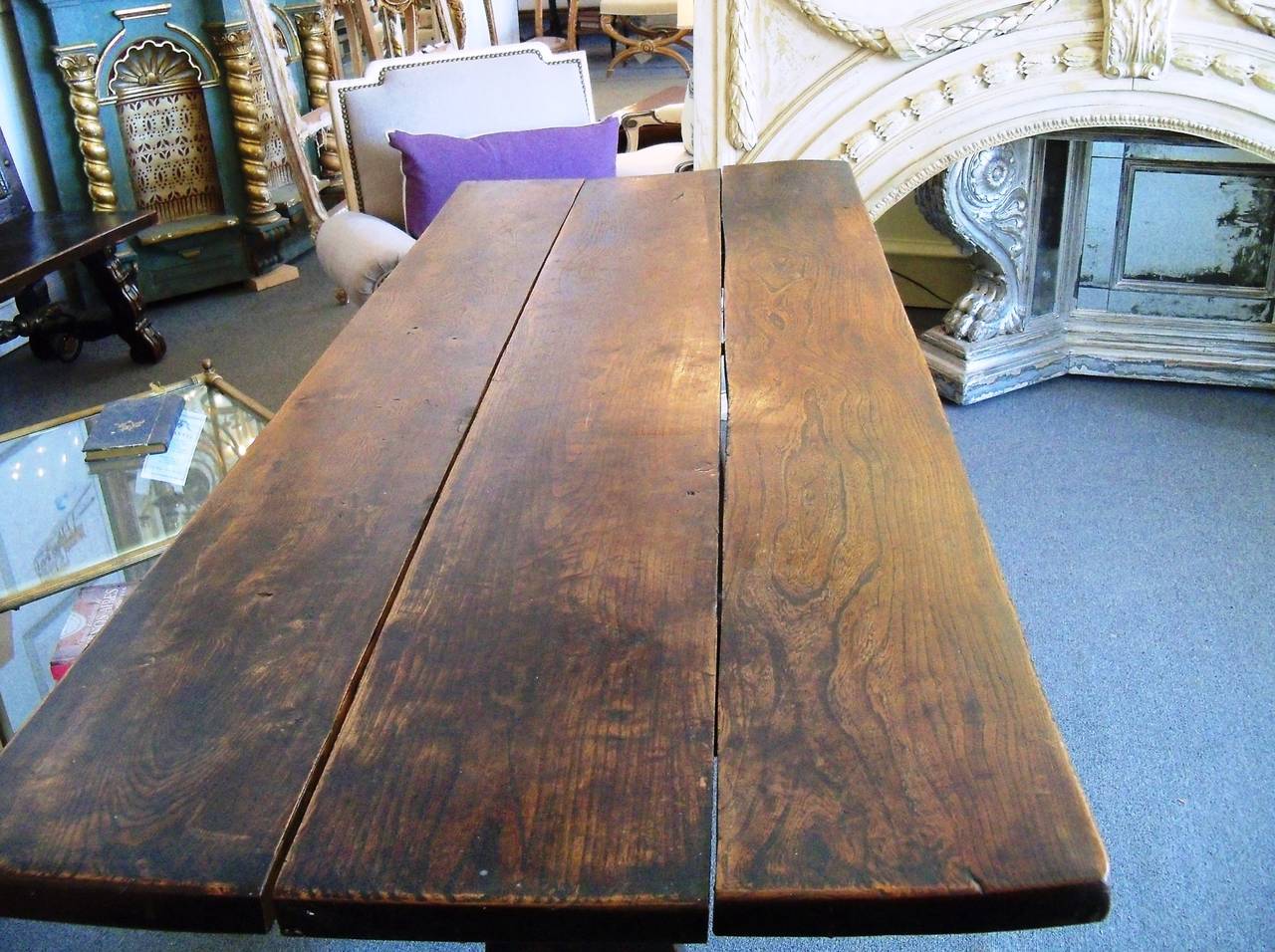 The rectangular plank top of this 19th century Italian walnut table is raised on a simple trestle form base with a stretcher. Years of use have given this piece a truly luminous patina. It would be lovely as a small dining table, writing table, sofa