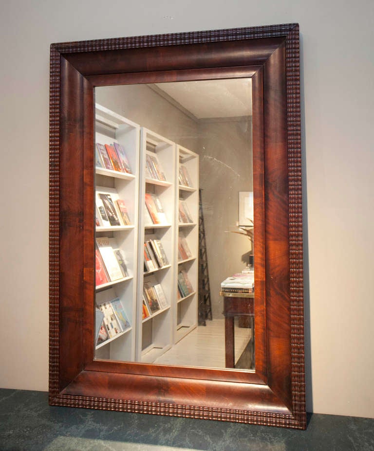 Mahogany framed Federalist mirror with carved edging.
