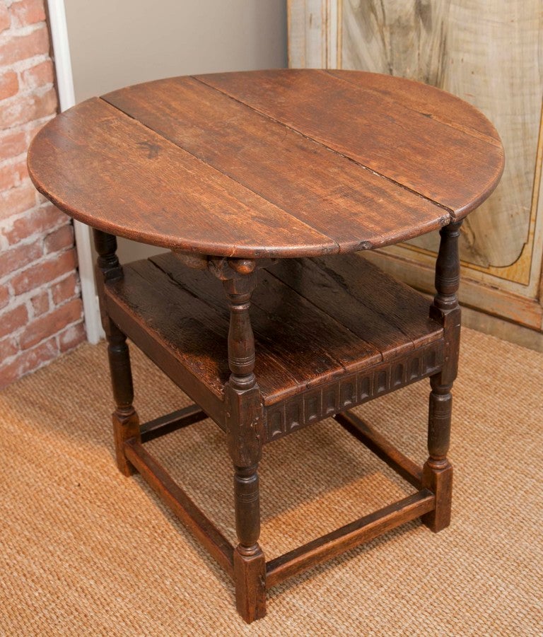 British Colonial style table that converts into a chair by flipping back the table top.  Attractive carved detail on legs and apron.  As a chair, overall height measures 52