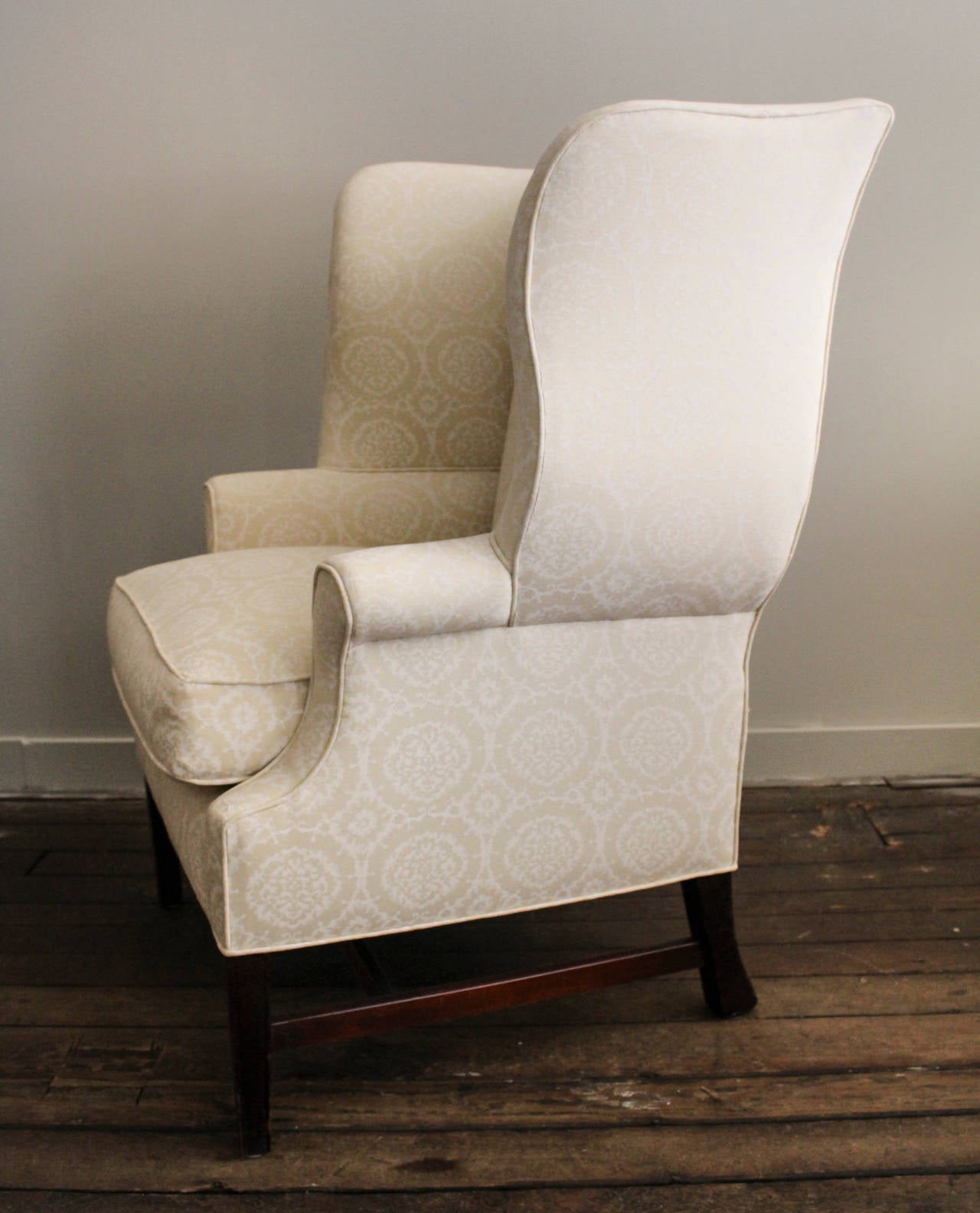 Vintage Wing Back Chair on Stretcher Base with Feather and Down Seat Cushion.  Chair Has Been Newly Reupholstered in a Madeline Weinrib White-on-Khaki Medallion Blockprint.