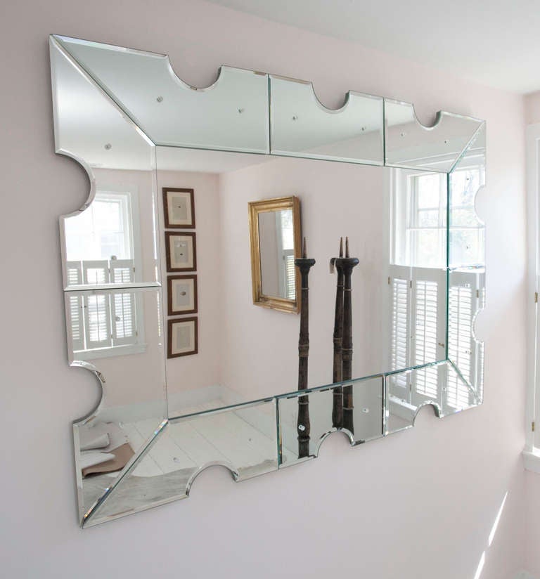 1940s style monumental mirror framed with partitioned, scalloped and beveled mirror surround.
