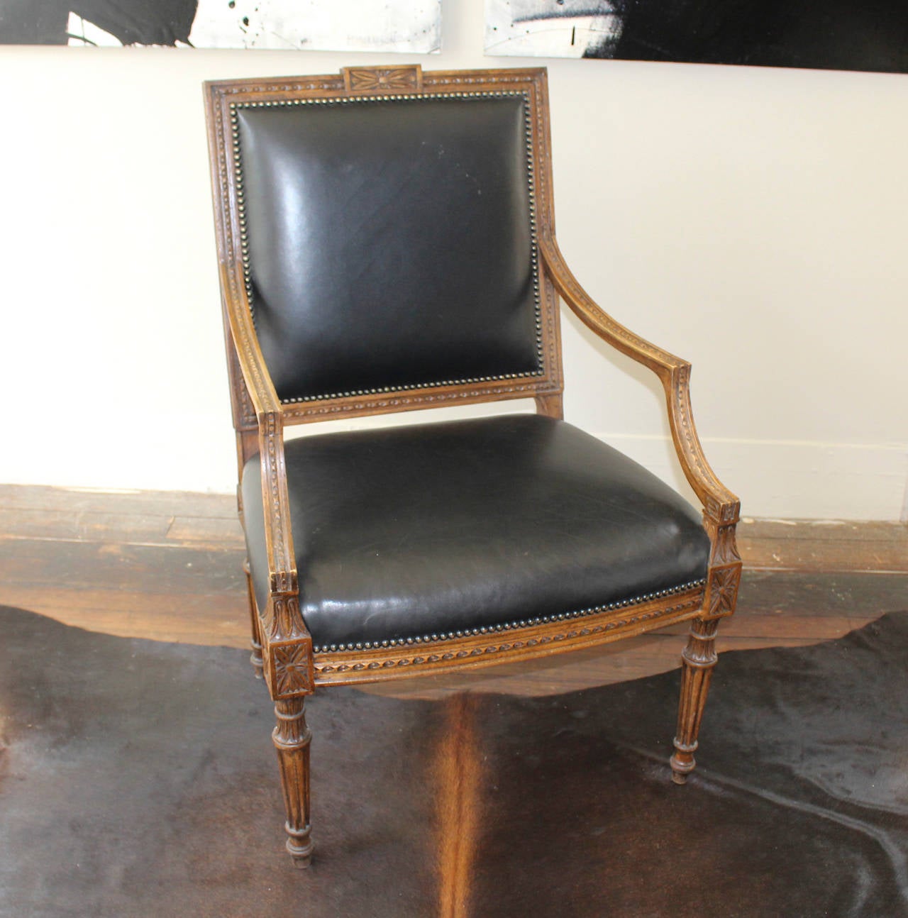 Leather upholstered bergere with carved frame and brass nailheads.
Ideal as a desk or occasional chair.