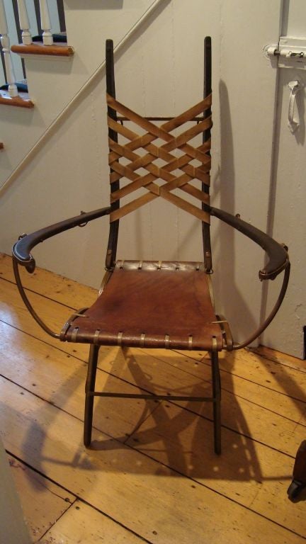 A very unusual and wonderful 'Harness' style arm chair fabricated from iron, wood, leather and rawhide.  These chairs are designed and made by Alberto Marconetti in Argentina, and each chair is signed 'A.Marconetti' on the lower left leather strap
