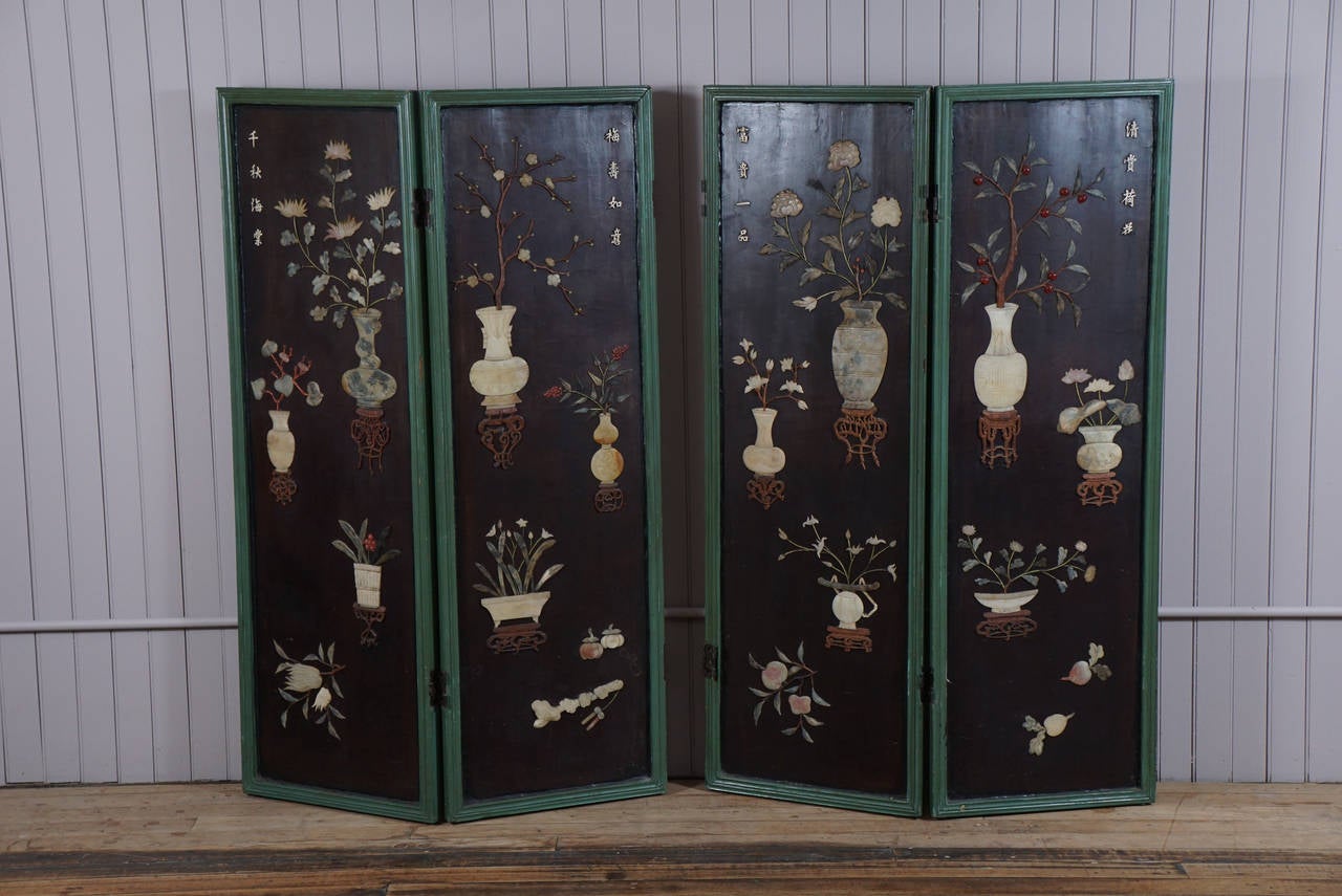 Medium sized folding screen - presently in two parts - semi precious stones - floral motif - dark brown background - green painted trim - shattered silk on reverse sides - attachments added for wall hanging.