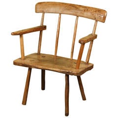 An Irish Pine and Oak "Hearthside" Chair, circa 1840