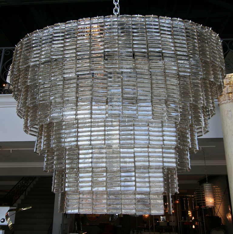 Large oval smoked glass Murano chandelier with eight tiers of rectangular glass and sixteen-light.