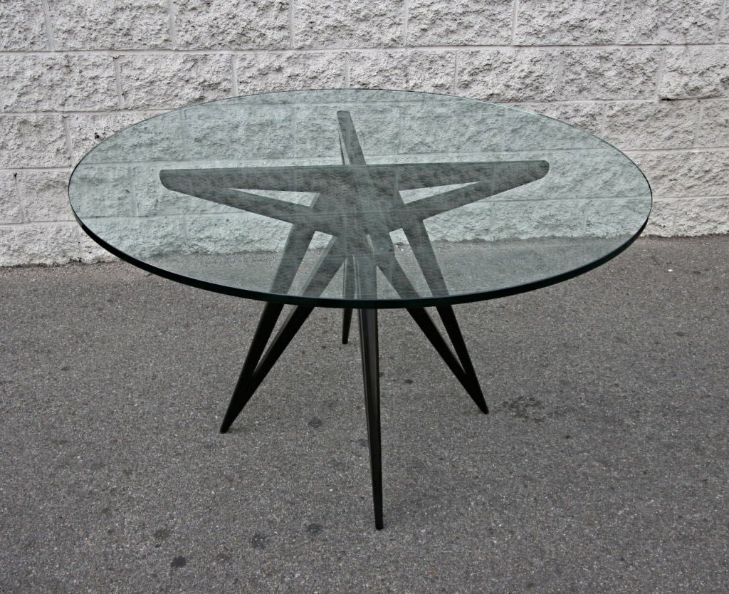 Custom star leg round ebonized wood dining table for four with a glass top by Adesso Imports

Can be done in different woods or with a wood top.