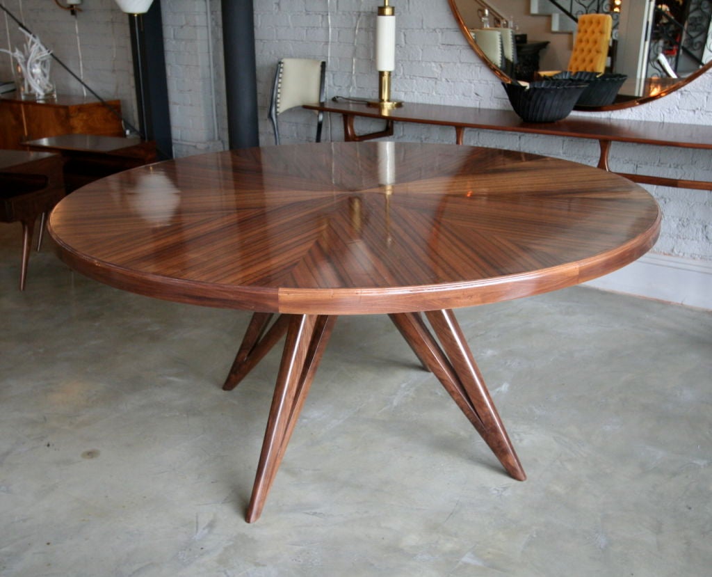 Custom star leg round top dining table for eight by Adesso Imports.

Can be done in different woods or with a glass top. See U12011481751004 for a smaller version with a glass top.
 