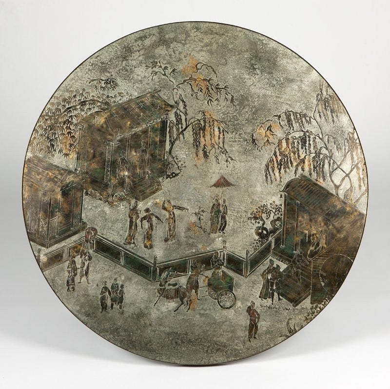 Beautiful 60's Phillip and Kelvin LaVerne acid-etched design , inlaid, and patinated bronze over pewter and wood. The circular top depicts a Chionsiserie scene of figures and pavilions in a village. The legs are modeled to resemble bamboo.

Please