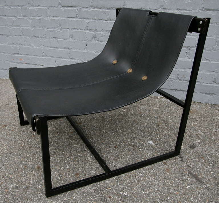 Pair of chairs by Julio Katinski upholstered in black leather with metal and wood frame.