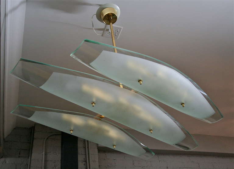 Dominici 1960s chandelier with three long clear and frosted glass pieces on a brass frame.